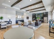 Thumbnail 3 of 22 - a large lobby with tables and chairs and a reception area