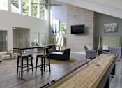Thumbnail 4 of 35 - A modern living room with a long wooden table and bar stools.