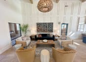 Thumbnail 5 of 23 - A living room with a large sectional sofa, a coffee table, and a large woven light fixture.