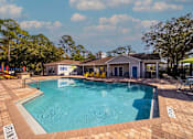Thumbnail 28 of 49 - A swimming pool with a building in the background.