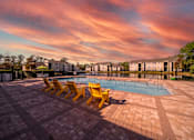 Thumbnail 31 of 49 - A pool surrounded by yellow sun loungers.