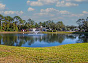 Thumbnail 47 of 49 - A fountain in the middle of a lake surrounded by trees.