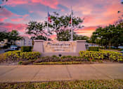 Thumbnail 48 of 49 - The entrance to Coastline Cove Estates is framed by a beautiful sunset.