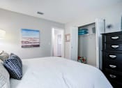 Thumbnail 13 of 26 - A bedroom with a large bed and a painting on the wall at Coral Club Apartments in Bradenton, FL