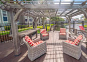Thumbnail 13 of 25 - a patio with chairs and a table and a pergola