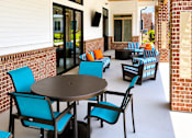 Thumbnail 28 of 35 - A patio with a table and chairs.