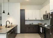 Thumbnail 27 of 47 - Modern kitchen with sleek design and stainless steel appliances in Apollo Beach, Florida.