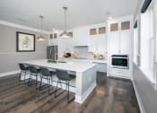 Thumbnail 4 of 54 - a kitchen with white cabinets and a white counter top