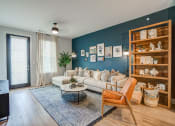 Thumbnail 36 of 56 - a living room with a blue accent wall and a white couch