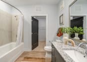 Thumbnail 44 of 56 - a bathroom with gray walls and a white bathtub