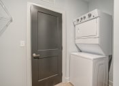 Thumbnail 39 of 56 - a small laundry room with a washer and dryer