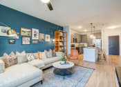 Thumbnail 34 of 56 - a living room with a blue accent wall and a white couch