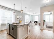 Thumbnail 31 of 56 - an open floor plan with an island kitchen and living room