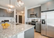 Thumbnail 26 of 56 - a kitchen with stainless steel appliances and granite counter tops