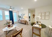 Thumbnail 13 of 23 - A living room with a dining table and chairs.