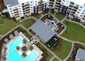 Thumbnail 23 of 28 - A large swimming pool surrounded by a concrete patio and a grassy area.