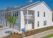 Thumbnail 64 of 71 - a row of townhomes with a car parked in front of them
