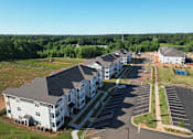 Thumbnail 31 of 40 - Athens, GA, Pet Friendly Apartments - Classic City Flats - Aerial View Of The Apartment Building Aeriel View With Parking Lot, Grass, And Trees.