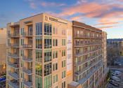 Thumbnail 45 of 47 - an apartment building with a sunset in the background