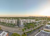 Thumbnail 38 of 38 - an aerial view of an empty parking lot with apartment buildings and a city skyline