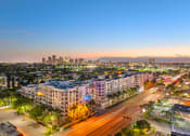 Thumbnail 36 of 38 - an aerial view of a city at sunset with traffic and buildings