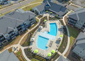 Thumbnail 26 of 28 - an overhead view of a swimming pool in an apartment complex