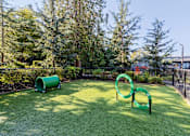 Thumbnail 23 of 27 - A playground with green and yellow play equipment.