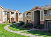 Thumbnail 39 of 51 - Apartment buildings with a green lawn in front.