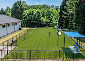 Thumbnail 34 of 37 - A park with a blue tarp and a black fence.