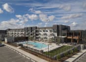 Thumbnail 39 of 40 - an aerial view of an apartment building with a swimming pool