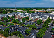 Thumbnail 43 of 43 - A parking lot in front of a large apartment complex.