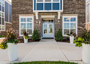 Thumbnail 27 of 30 - The front of a building with a glass door and windows.