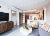 Thumbnail 5 of 31 - a living room with a couch and a television