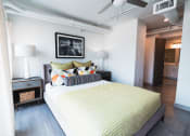 Thumbnail 8 of 31 - a bedroom with a large bed and a ceiling fan