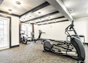 Thumbnail 14 of 45 - A gym with a rowing machine in the foreground.