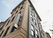 Thumbnail 22 of 45 - A tall building with a sign that says "The Astor Place".