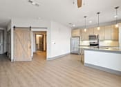 Thumbnail 15 of 43 - A kitchen area with a white counter and wooden floors.