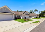 Thumbnail 50 of 53 - A row of houses with garages and driveways.