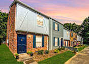 Thumbnail 22 of 25 - A row of houses with blue doors and windows.