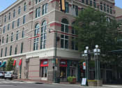 Thumbnail 1 of 7 - a large building on the corner of a city street