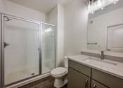 Thumbnail 16 of 35 - A bathroom with a toilet, sink, and shower.