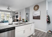 Thumbnail 3 of 21 - A kitchen with a stainless steel dishwasher and white cabinets.