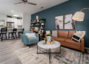 Thumbnail 7 of 21 - Alexandria, KY, Apartments with In-Unit Washer and Dryer - Elevation Apartment Homes - Modern Living Room With Leather Sofa, Round Coffee Table, And Wood Style Flooring.