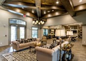 Thumbnail 11 of 31 - a large living room with couches and chairs and a fireplace