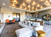 Thumbnail 9 of 27 - A modern living room with a grey carpet and a white sofa.