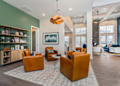 Thumbnail 16 of 35 - A living room with a green wall and a painting hanging on it.