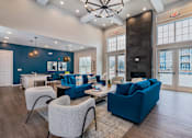 Thumbnail 17 of 35 - A living room with a blue couch and a fireplace.