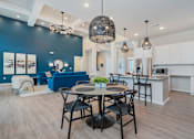 Thumbnail 20 of 35 - A modern dining area with a table set for four.