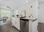 Thumbnail 4 of 35 - A modern kitchen with a stainless steel dishwasher and white cabinets.
