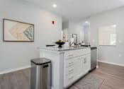 Thumbnail 2 of 35 - A modern kitchen with a stainless steel dishwasher and a trash can.